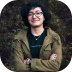 A Girl Smiling And Wearing Glasses